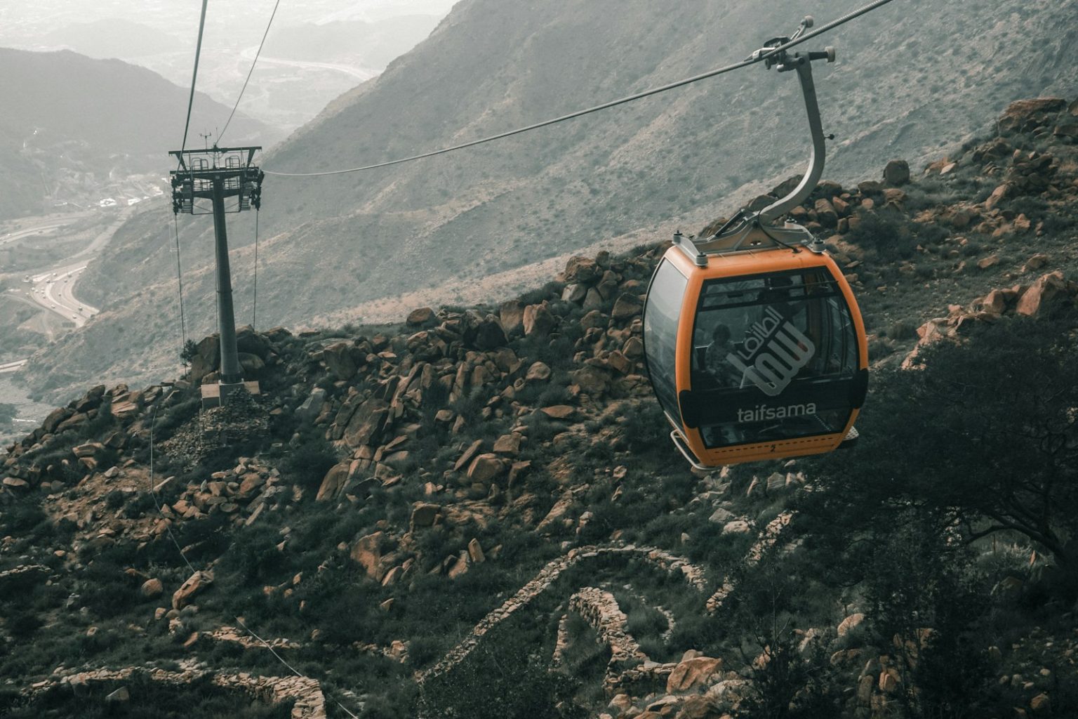 a cable car going up the side of a mountain